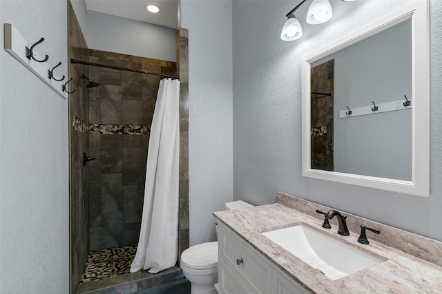 bathroom with a shower with curtain, vanity, and toilet