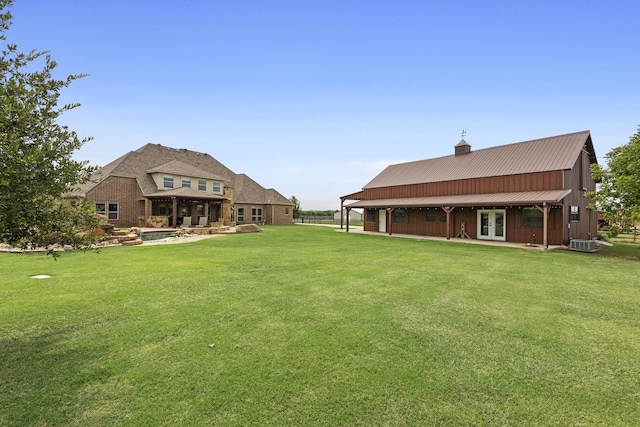 view of yard with a patio area, central AC, and french doors