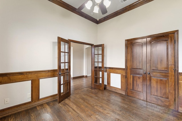 unfurnished room with dark hardwood / wood-style flooring, crown molding, french doors, and ceiling fan