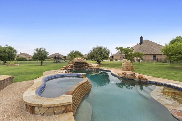 view of swimming pool featuring an in ground hot tub and a yard