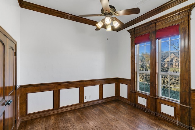 spare room featuring dark hardwood / wood-style flooring, ceiling fan, and crown molding