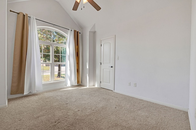 empty room with ceiling fan, carpet floors, and vaulted ceiling