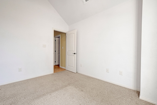 unfurnished room featuring light colored carpet and high vaulted ceiling