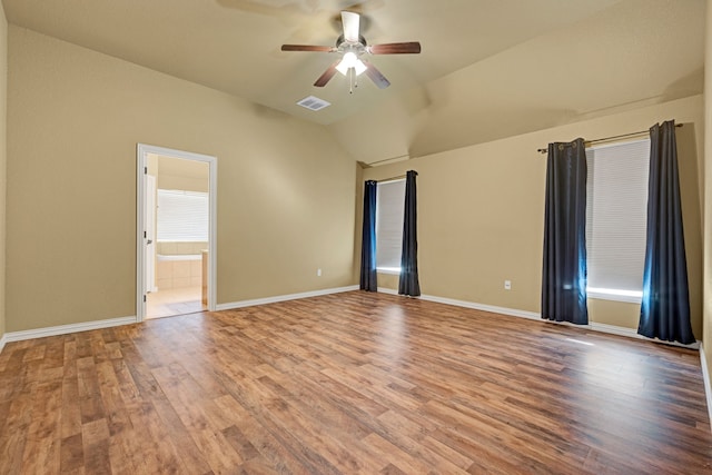 spare room with ceiling fan, lofted ceiling, and hardwood / wood-style flooring