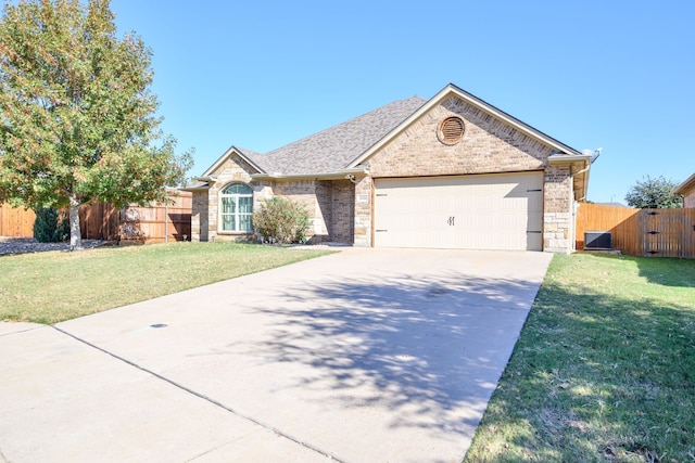 ranch-style house featuring a garage and a front lawn