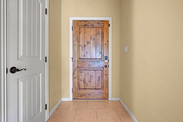 doorway featuring light tile patterned flooring