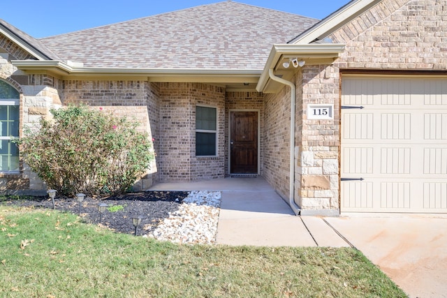 doorway to property with a garage