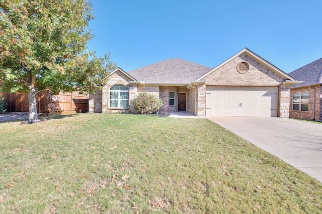 ranch-style house featuring a garage and a front yard