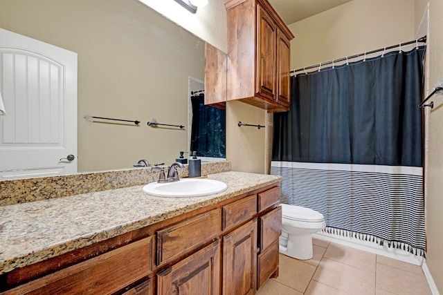 bathroom with tile patterned flooring, vanity, and toilet