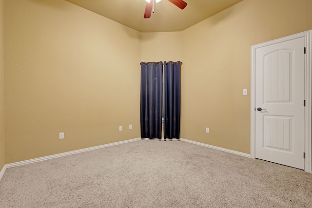 unfurnished room featuring ceiling fan and carpet floors