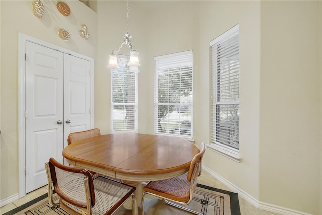 dining space with a chandelier and light tile patterned floors