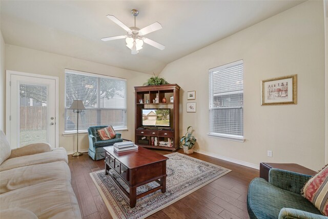 living room featuring ceiling fan, dark hardwood / wood-style flooring, and vaulted ceiling