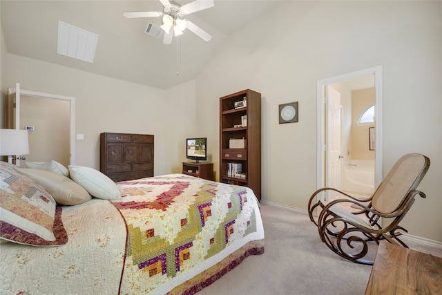 carpeted bedroom featuring vaulted ceiling, ensuite bath, and ceiling fan