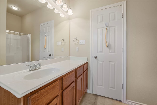 bathroom featuring tile patterned flooring, vanity, and walk in shower