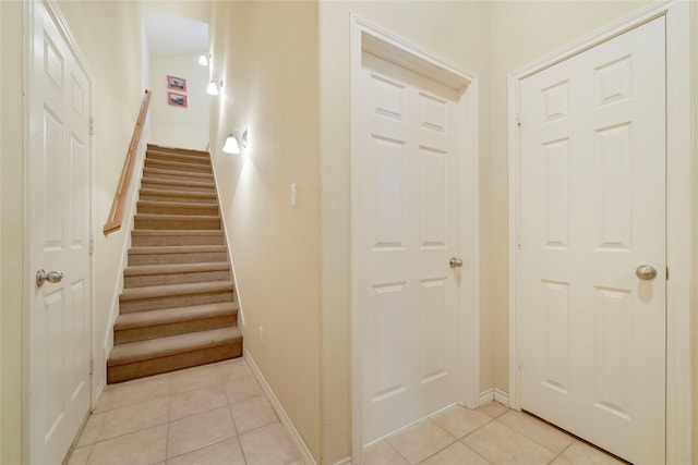 stairway with tile patterned flooring