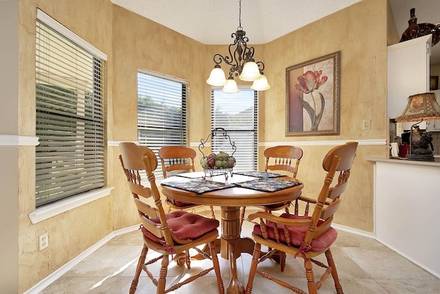 dining area with an inviting chandelier