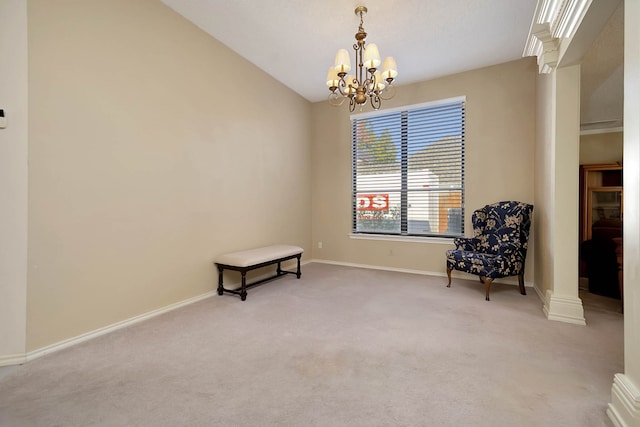 living area featuring a chandelier, light colored carpet, and ornate columns