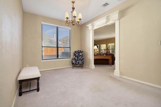 unfurnished room with carpet floors and a notable chandelier