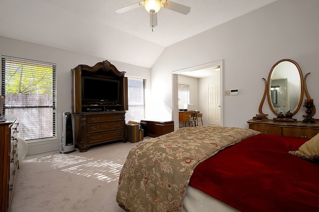 bedroom with light carpet, multiple windows, vaulted ceiling, and ceiling fan