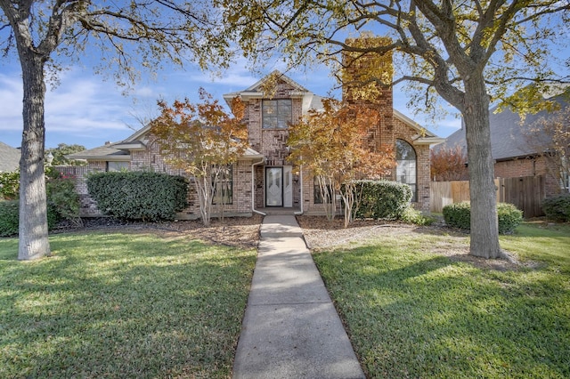 view of property hidden behind natural elements featuring a front yard