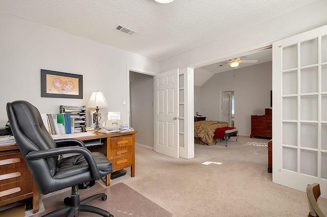 office space with light carpet, a textured ceiling, ceiling fan, and lofted ceiling