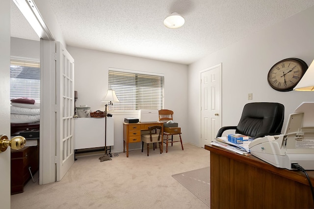 office featuring light colored carpet and a textured ceiling