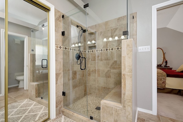 bathroom featuring tile patterned floors, a shower with door, and vaulted ceiling