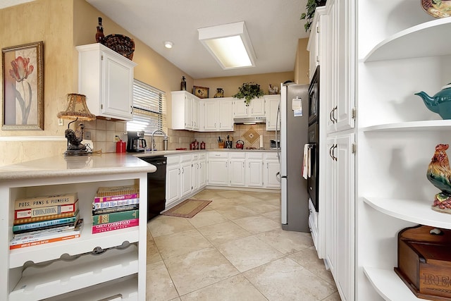 kitchen featuring decorative backsplash, sink, white cabinets, and black appliances