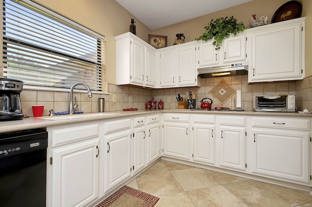 kitchen with decorative backsplash, sink, white cabinets, black dishwasher, and light tile patterned flooring