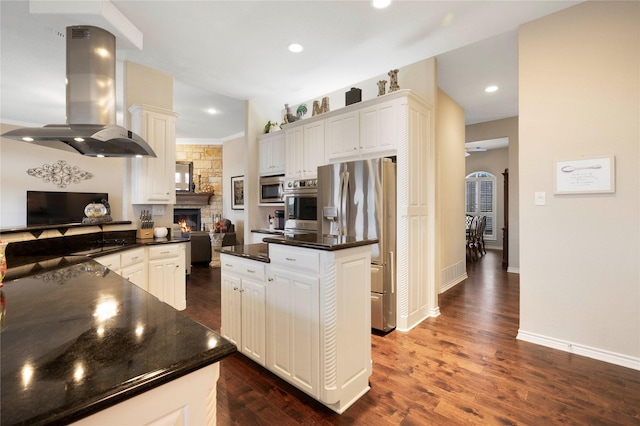 kitchen featuring island range hood, a kitchen island, stainless steel appliances, and white cabinetry