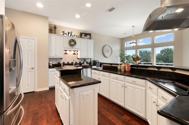 kitchen with a kitchen island, dark hardwood / wood-style flooring, ventilation hood, white cabinets, and appliances with stainless steel finishes