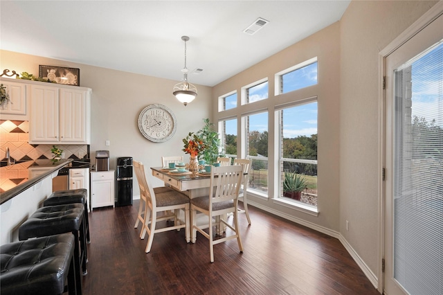 dining area with dark hardwood / wood-style flooring