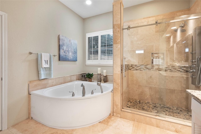 bathroom with tile patterned flooring and separate shower and tub