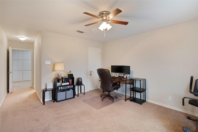 carpeted office featuring ceiling fan