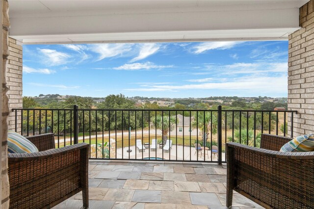 view of pool with area for grilling, french doors, a patio, and an outdoor fire pit