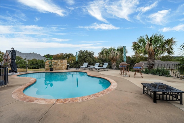 view of pool with a mountain view, a patio, and an outdoor fire pit