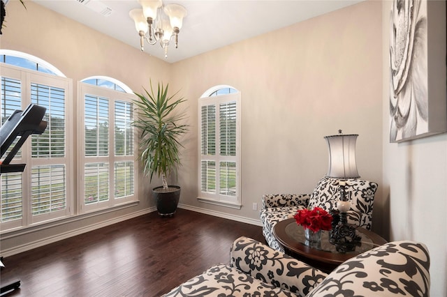 living area featuring a chandelier and dark wood-type flooring