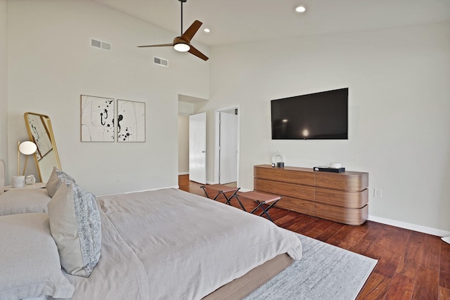 bedroom with high vaulted ceiling, ceiling fan, and dark wood-type flooring