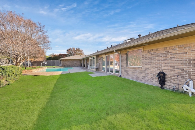 view of yard featuring a fenced in pool and a patio