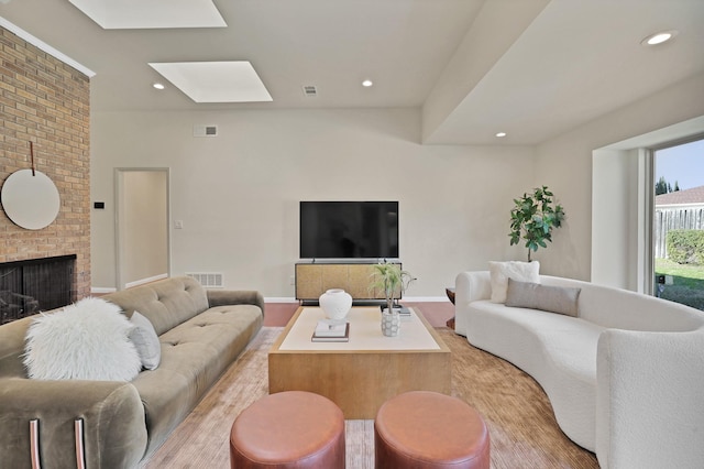 living room featuring a fireplace and light hardwood / wood-style flooring