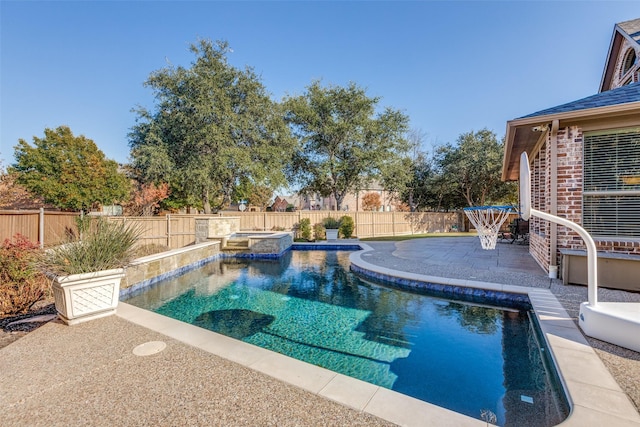 view of swimming pool featuring a patio and an in ground hot tub