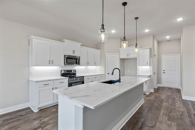 kitchen featuring white cabinets, sink, an island with sink, and stainless steel appliances