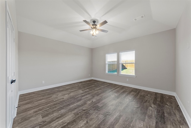 spare room featuring ceiling fan and dark hardwood / wood-style floors