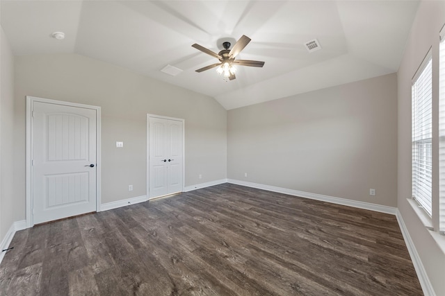 unfurnished bedroom featuring ceiling fan, lofted ceiling, and dark wood-type flooring