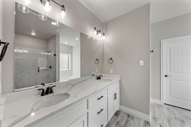 bathroom with hardwood / wood-style flooring, vanity, and a shower with door