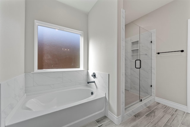 bathroom featuring separate shower and tub and plenty of natural light