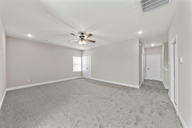 spare room with light carpet and ceiling fan