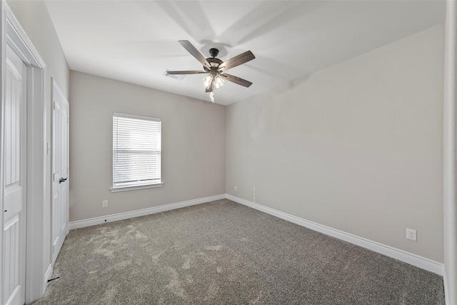 carpeted spare room with ceiling fan