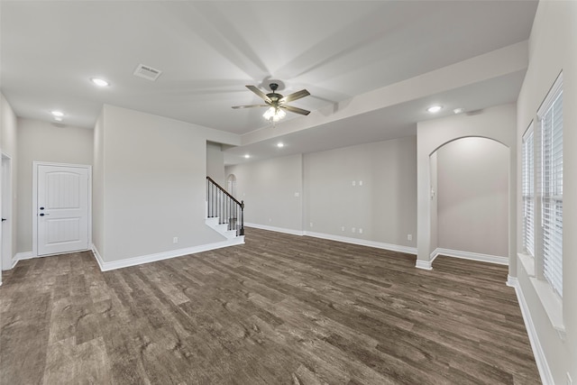 unfurnished room featuring ceiling fan and dark wood-type flooring