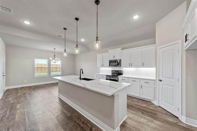 kitchen featuring a kitchen island with sink, white cabinets, sink, decorative light fixtures, and stainless steel appliances